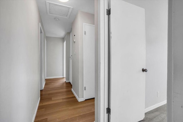 hallway with light hardwood / wood-style floors