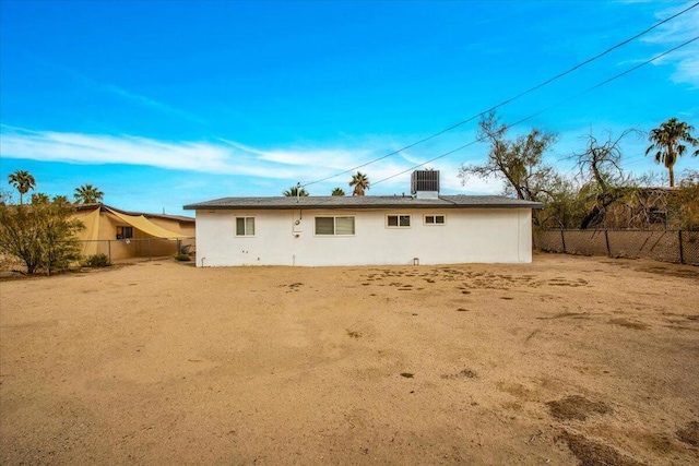 rear view of property with cooling unit