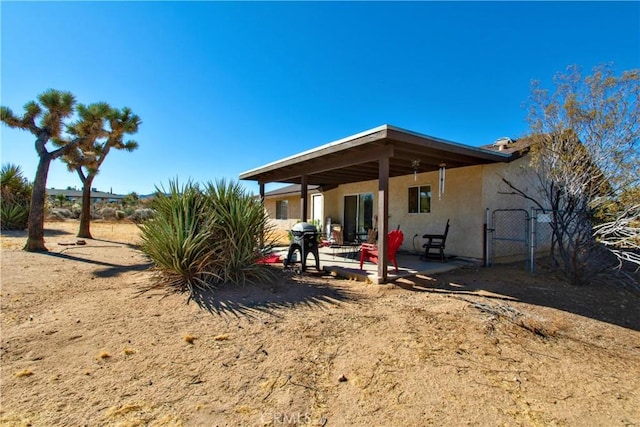 rear view of property featuring a patio