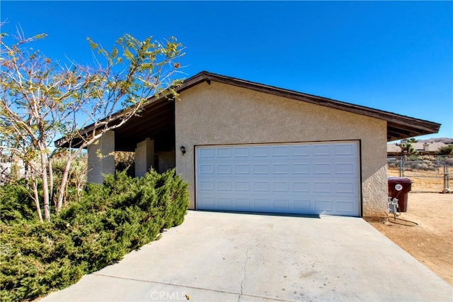 exterior space with a garage and an outbuilding