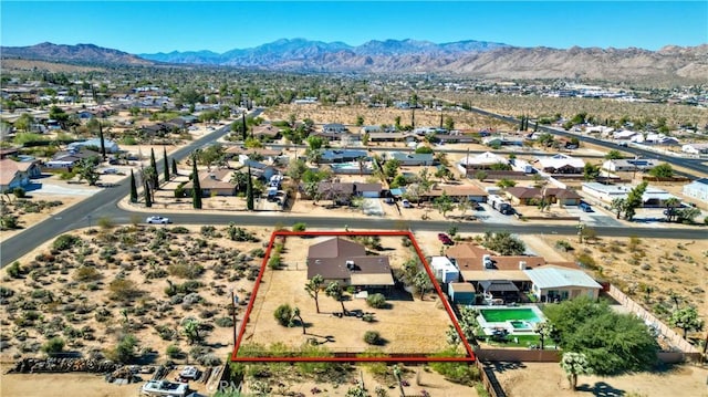 birds eye view of property with a mountain view