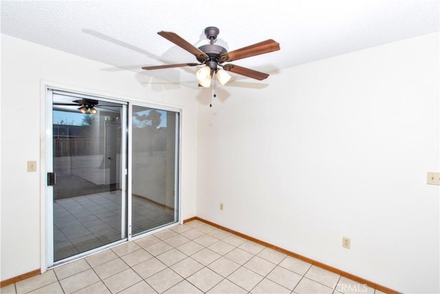 tiled empty room featuring ceiling fan and a textured ceiling