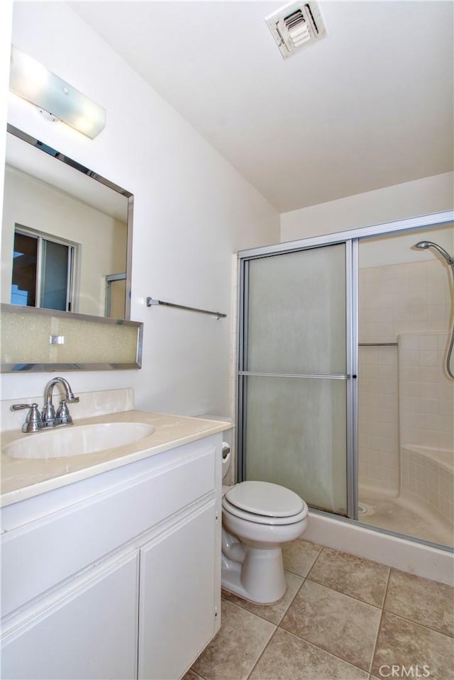 bathroom with toilet, walk in shower, and vanity