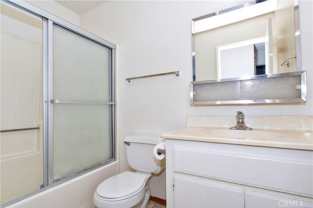 full bathroom featuring enclosed tub / shower combo, toilet, and vanity