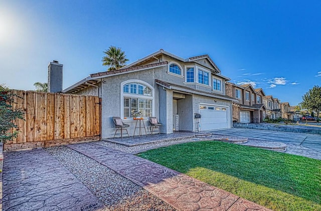 view of front of house with a garage and a front lawn