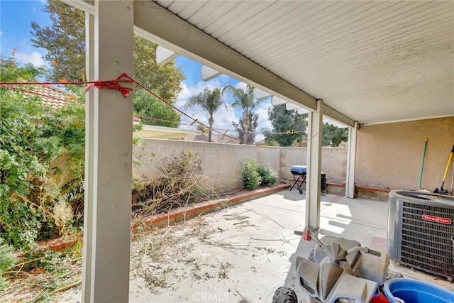 view of patio featuring central AC unit and fence