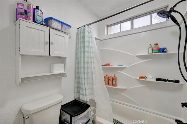 bathroom featuring shower / bath combination with curtain and toilet
