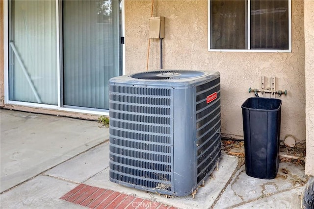 exterior details with central air condition unit and stucco siding