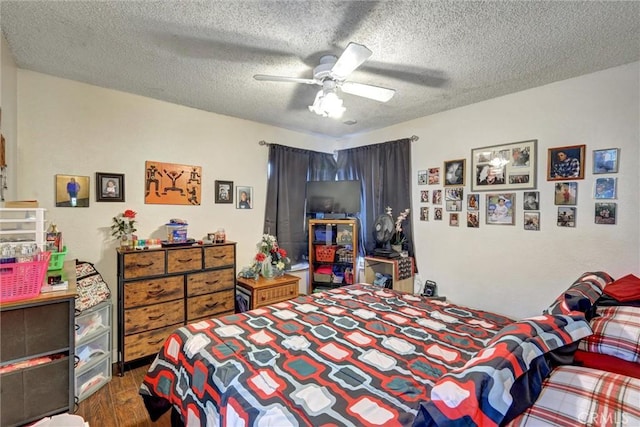 bedroom featuring ceiling fan, a textured ceiling, and dark wood-type flooring