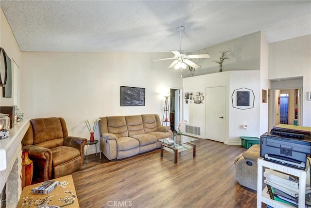 living room with wood-type flooring, a textured ceiling, high vaulted ceiling, and ceiling fan