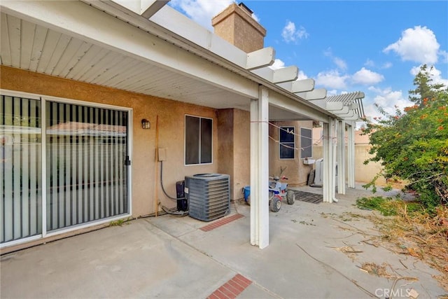 view of patio featuring central air condition unit and a pergola