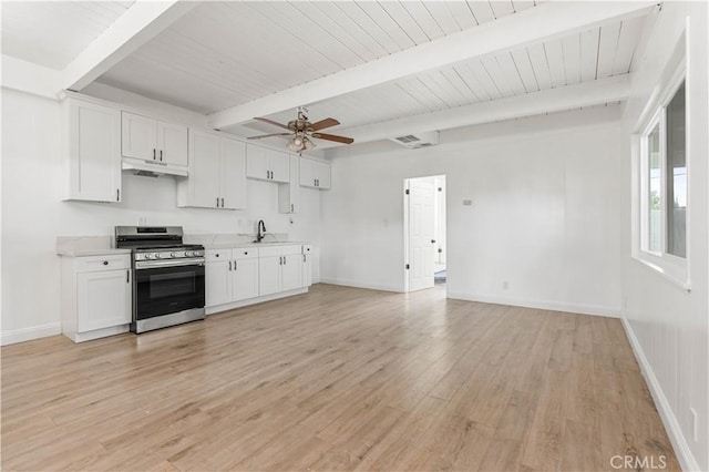 kitchen featuring white cabinets, beam ceiling, stainless steel stove, and light hardwood / wood-style flooring