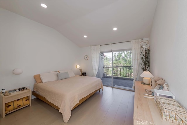 bedroom with wood-type flooring, access to outside, and vaulted ceiling