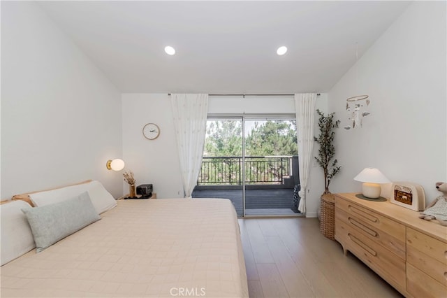 bedroom with access to outside and light hardwood / wood-style flooring