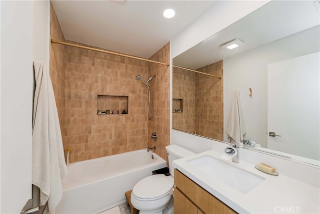 full bathroom featuring vanity, toilet, and tiled shower / bath