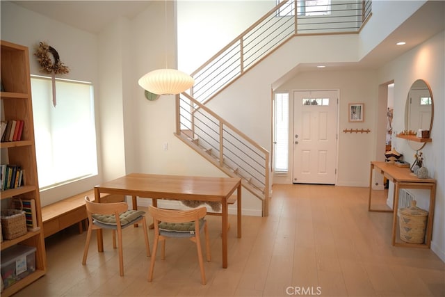 entrance foyer with light hardwood / wood-style flooring and a high ceiling