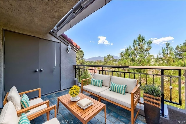 balcony featuring a mountain view and outdoor lounge area