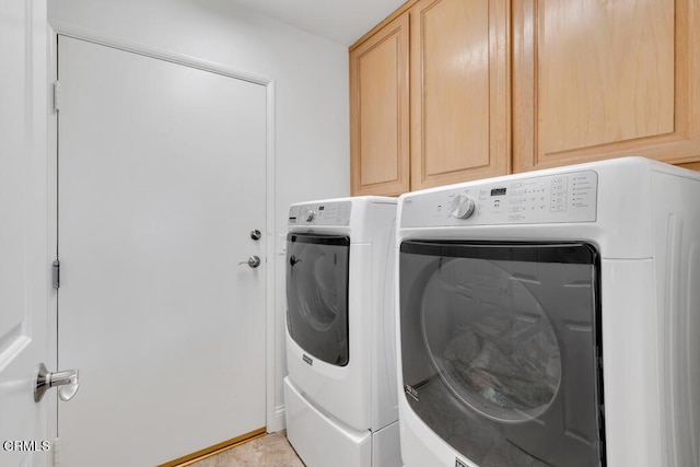 washroom featuring separate washer and dryer and cabinets