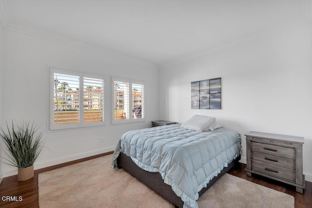 bedroom featuring crown molding and dark hardwood / wood-style flooring