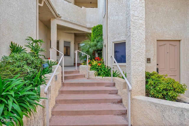 view of exterior entry featuring a balcony