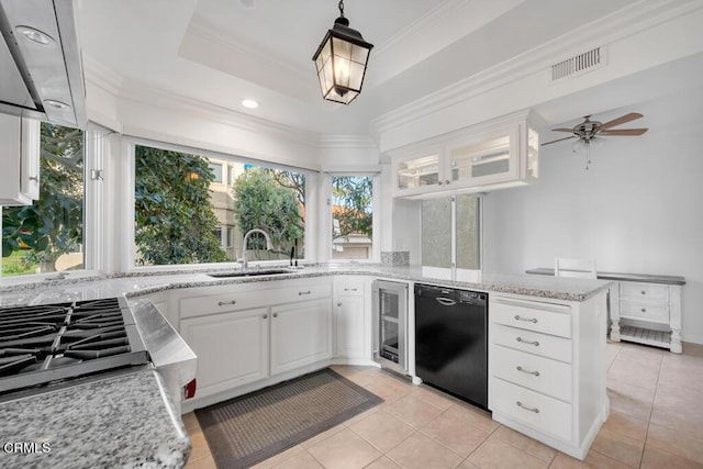 kitchen with a wealth of natural light, white cabinetry, and sink