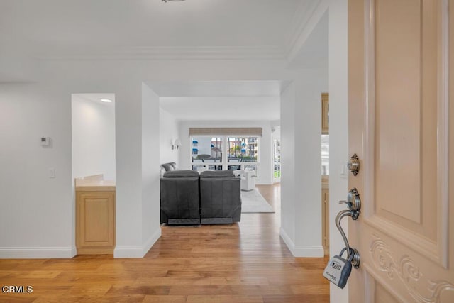 entryway featuring light hardwood / wood-style flooring and ornamental molding