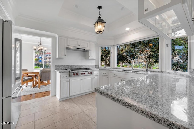 kitchen featuring a healthy amount of sunlight, white cabinetry, appliances with stainless steel finishes, and light hardwood / wood-style flooring