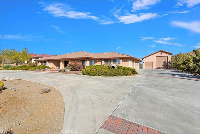 ranch-style home with an outdoor structure and a garage