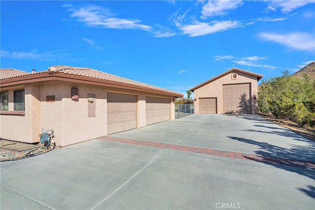 exterior space featuring a garage and an outdoor structure