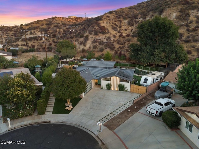 aerial view at dusk featuring a mountain view