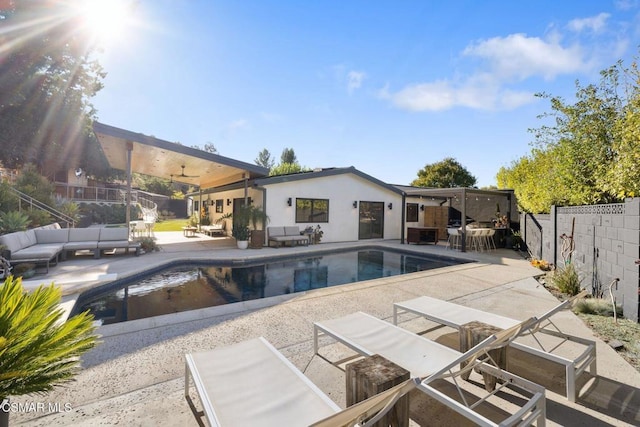 view of swimming pool with ceiling fan, an outdoor hangout area, and a patio