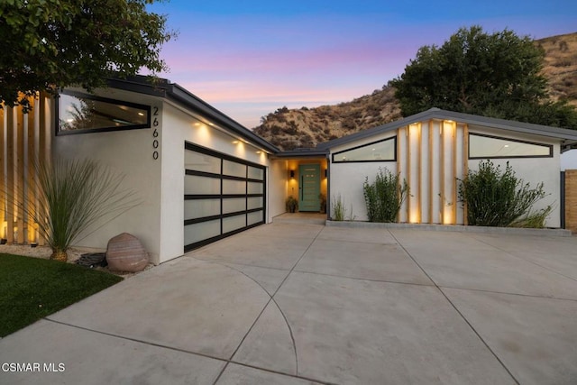 view of garage at dusk