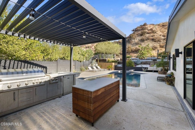 view of patio / terrace with area for grilling and a fenced in pool