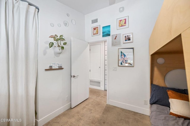 corridor with light colored carpet