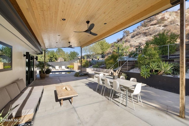 view of patio / terrace with outdoor lounge area, ceiling fan, and a mountain view