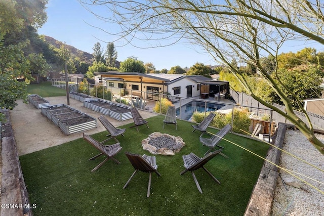 exterior space with a fenced in pool, a mountain view, and a yard