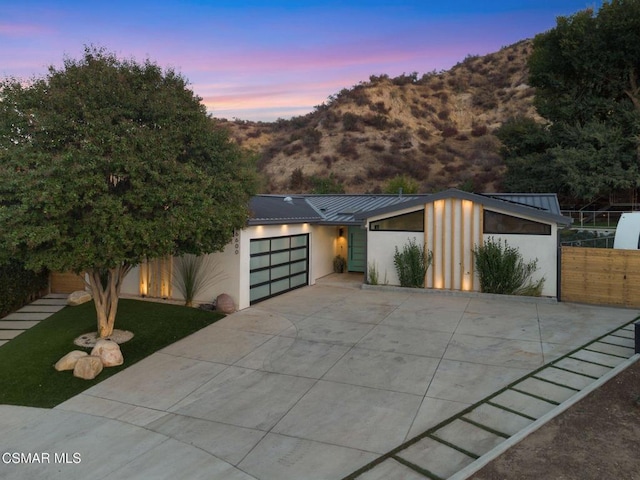 contemporary house with a mountain view and a garage