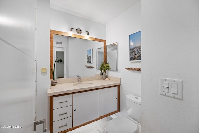 bathroom featuring vanity and toilet