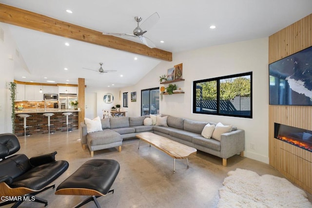 living room with ceiling fan, a large fireplace, and lofted ceiling with beams