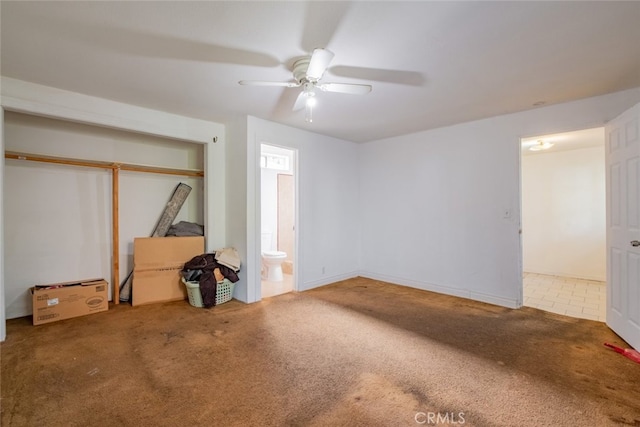 bedroom with ceiling fan, ensuite bathroom, a closet, and carpet floors