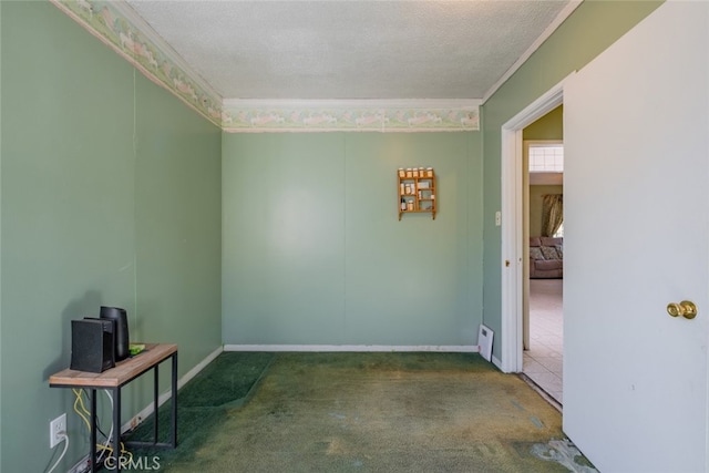 carpeted empty room featuring a textured ceiling and ornamental molding