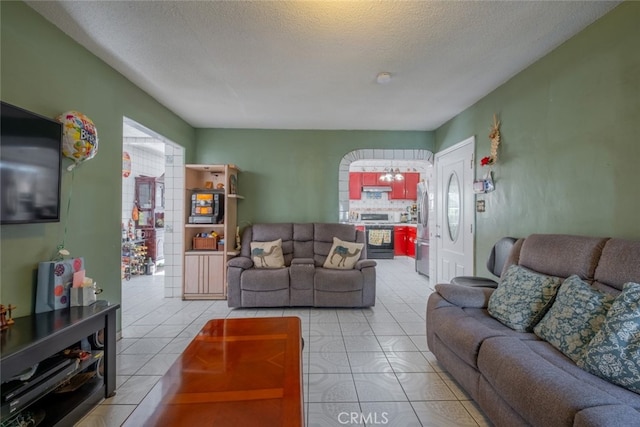 living room with light tile patterned floors and a textured ceiling