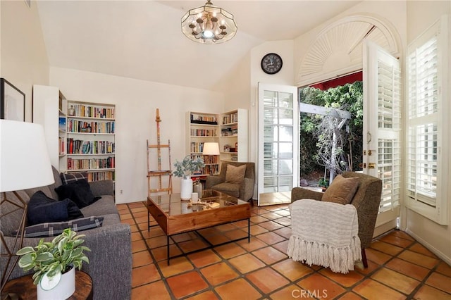 interior space featuring tile patterned floors, vaulted ceiling, and an inviting chandelier