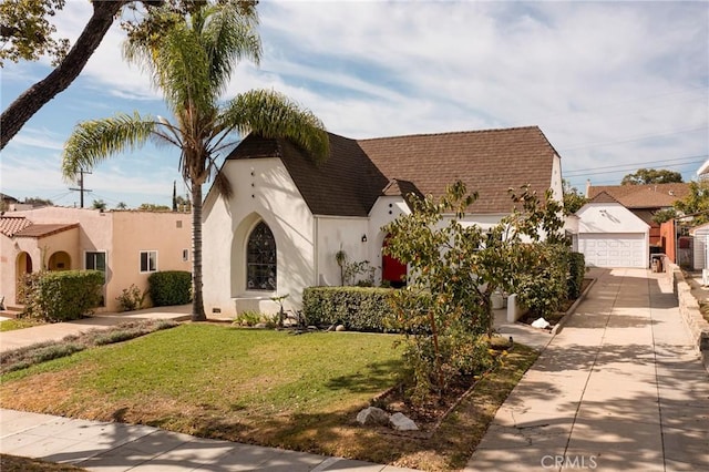 view of front of home with a garage and a front lawn