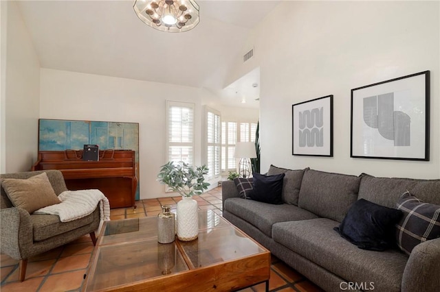 living room with light tile patterned floors and high vaulted ceiling