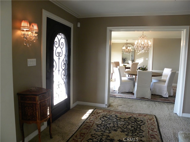 entryway with crown molding, a chandelier, and carpet