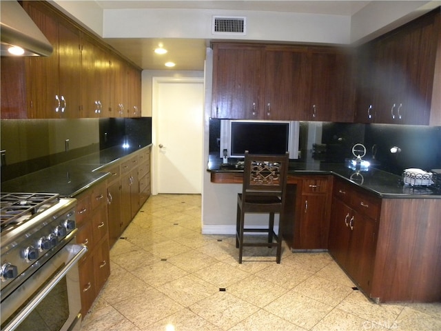 kitchen featuring ventilation hood, stainless steel range, and backsplash