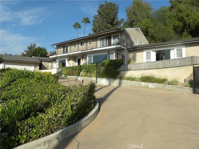 view of front of house featuring a balcony