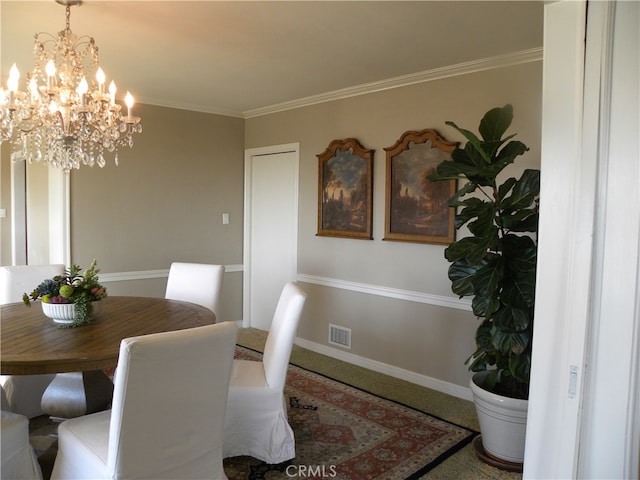 dining room with crown molding and an inviting chandelier