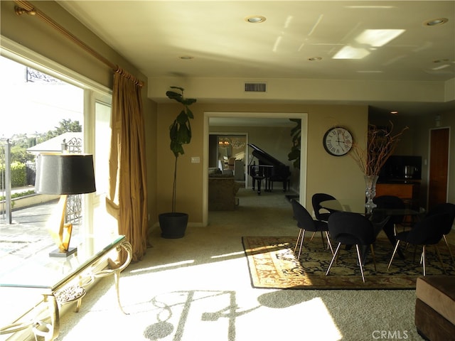 miscellaneous room featuring light colored carpet